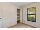 Bedroom with built-in shelving and a window at 10736 Se 51St Ct, Belleview, FL 34420