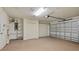 Spacious garage with storage cabinets and overhead door at 10736 Se 51St Ct, Belleview, FL 34420