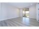 Bright bedroom featuring sliding glass doors to balcony and wood-look floors at 13370 Alderley Dr, Orlando, FL 32832