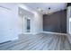 Bright bedroom with wood-look floors and an accent wall at 13370 Alderley Dr, Orlando, FL 32832