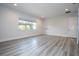 Spacious bedroom with large window and wood-look floors at 13370 Alderley Dr, Orlando, FL 32832