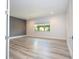 Bright bedroom featuring wood-look flooring and large window at 13370 Alderley Dr, Orlando, FL 32832
