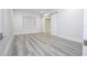 Spacious bedroom with barn doors to closet and wood-look floors at 13370 Alderley Dr, Orlando, FL 32832