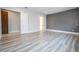 Spacious bedroom with wood-look floors and access to hallway at 13370 Alderley Dr, Orlando, FL 32832