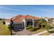 House with tile roof and landscaping, viewed from the street at 13370 Alderley Dr, Orlando, FL 32832