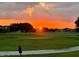 Picturesque sunset view over the green golf course and upscale homes at 13370 Alderley Dr, Orlando, FL 32832