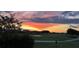 Scenic golf course view at sunset with colorful sky and lush green fairways at 13370 Alderley Dr, Orlando, FL 32832