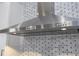 Stainless steel range hood with overhead lighting at 13370 Alderley Dr, Orlando, FL 32832