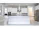Modern kitchen with white cabinets, stainless steel appliances and breakfast bar at 13370 Alderley Dr, Orlando, FL 32832