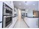 Modern kitchen with white cabinets, stainless steel appliances and island at 13370 Alderley Dr, Orlando, FL 32832