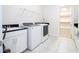 Bright laundry room with washer, dryer and storage at 13370 Alderley Dr, Orlando, FL 32832