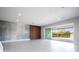 Open living room with modern wall features and access to patio at 13370 Alderley Dr, Orlando, FL 32832