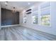 Spacious living room featuring large windows and stylish chandelier at 13370 Alderley Dr, Orlando, FL 32832