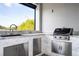 Outdoor kitchen with stainless steel appliances and granite countertops at 13370 Alderley Dr, Orlando, FL 32832