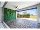 Covered patio with a living wall and golf course view at 13370 Alderley Dr, Orlando, FL 32832