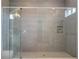 Large walk-in shower with gray tile and glass enclosure at 13370 Alderley Dr, Orlando, FL 32832