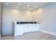 Modern wet bar with white cabinets and granite countertop at 13370 Alderley Dr, Orlando, FL 32832