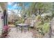 Charming brick patio with table, chairs, and lush greenery at 135 E 9Th Ave, Mount Dora, FL 32757