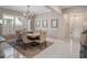 Elegant dining room with a wooden table, tufted chairs, and decorative wall panels at 15312 Gilligan Ct, Winter Garden, FL 34787