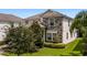 Two story house with stone accents and lush landscaping at 1555 Palmero Way, Davenport, FL 33896