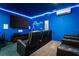 Home theater with reclining seats and blue lighting at 1555 Palmero Way, Davenport, FL 33896