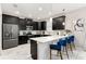 Modern kitchen with black cabinets, white quartz countertops and breakfast bar at 1555 Palmero Way, Davenport, FL 33896