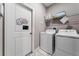 Convenient laundry room with washer, dryer, and storage at 1555 Palmero Way, Davenport, FL 33896