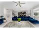 Open concept living room with sectional sofa and view into kitchen at 1555 Palmero Way, Davenport, FL 33896