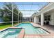 Screened pool and spa with lounge chairs at 1555 Palmero Way, Davenport, FL 33896