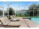 Relaxing poolside view with lounge chairs and spa at 1555 Palmero Way, Davenport, FL 33896