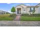 Attractive single-story home with landscaped yard and walkway at 15657 Pelican Cay Dr, Winter Garden, FL 34787