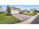 One car garage with paver driveway and landscaping at 15657 Pelican Cay Dr, Winter Garden, FL 34787