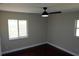 Bright bedroom with dark hardwood floors and a ceiling fan at 17211 Se 160Th Avenue Rd, Weirsdale, FL 32195