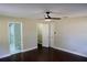 Main bedroom with private bathroom access and ceiling fan at 17211 Se 160Th Avenue Rd, Weirsdale, FL 32195