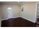 Bright entryway with dark hardwood floors and white door at 17211 Se 160Th Avenue Rd, Weirsdale, FL 32195