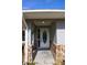 Inviting front entrance with stone detailing and a white door at 17211 Se 160Th Avenue Rd, Weirsdale, FL 32195