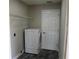 Bright laundry room with washer, dryer, and shelving at 17211 Se 160Th Avenue Rd, Weirsdale, FL 32195
