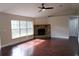 Spacious living room with corner fireplace and hardwood floors at 17211 Se 160Th Avenue Rd, Weirsdale, FL 32195