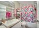 Clean bathroom with floral shower curtain, vanity, and granite countertop at 1748 Christina Lee Lane, St Cloud, FL 34769