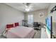 Comfortable bedroom with striped bedding, a workspace, and large TV at 1748 Christina Lee Lane, St Cloud, FL 34769