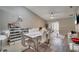 Stylish dining room with modern table and chairs, sliding door to the outside, and open floorplan at 1748 Christina Lee Lane, St Cloud, FL 34769