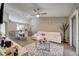 Open-concept living room boasts lots of natural light, neutral walls, modern furnishings, and hardwood floors at 1748 Christina Lee Lane, St Cloud, FL 34769