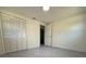 Spacious bedroom featuring grey flooring and a large closet at 1821 Rogers Ave, Maitland, FL 32751