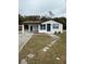 Newly renovated home with a modern exterior, driveway, and landscaped yard at 1821 Rogers Ave, Maitland, FL 32751