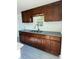 Modern kitchen with dark wood cabinets and granite countertops at 1821 Rogers Ave, Maitland, FL 32751