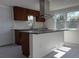 Modern kitchen with island, granite countertops, and stainless steel appliances at 1821 Rogers Ave, Maitland, FL 32751