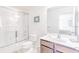 Bright bathroom with a tub shower combo and vanity at 2501 Dharma Cir, Kissimmee, FL 34746