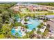 Aerial view of resort-style community pool with lounge chairs and palm trees at 2501 Dharma Cir, Kissimmee, FL 34746
