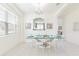 Modern dining room with a glass-top table and white chairs at 2501 Dharma Cir, Kissimmee, FL 34746