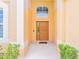 Inviting front door entrance with a light beige exterior at 2501 Dharma Cir, Kissimmee, FL 34746